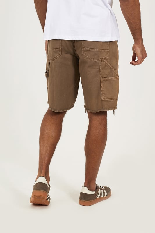 Bring a rugged twist to your summer wardrobe with these carpenter-style denim shorts from Brave Soul. Designed in a loose fit with a classic button waist, these shorts deliver easy comfort and authentic utility style. Crafted from sturdy denim, they feature carpenter-style thigh pockets and a raw hem for an effortlessly worn-in edge. Model wears UK size M.