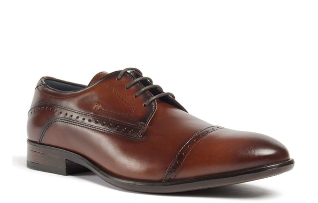 Introducing the Ralph, a sophisticated toe-cap Oxford style crafted from premium Italian leather, meticulously finished to deliver a rich, deep color. Elevate your formal attire with the closed Oxford lace-up closure, while the concealed padded collar and tongue enhance comfort. The Ortholite foam insole offers long-lasting cushioning and breathability, ensuring your feet stay comfortable throughout the day. The Ralph is the perfect blend of timeless style and modern comfort.- Premium Italian leather upper- Lace-up closure- Concealed padded collar and tongue- Ortholite foam insole