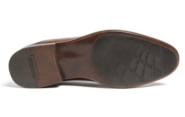 Introducing the Ralph, a sophisticated toe-cap Oxford style crafted from premium Italian leather, meticulously finished to deliver a rich, deep color. Elevate your formal attire with the closed Oxford lace-up closure, while the concealed padded collar and tongue enhance comfort. The Ortholite foam insole offers long-lasting cushioning and breathability, ensuring your feet stay comfortable throughout the day. The Ralph is the perfect blend of timeless style and modern comfort.- Premium Italian leather upper- Lace-up closure- Concealed padded collar and tongue- Ortholite foam insole