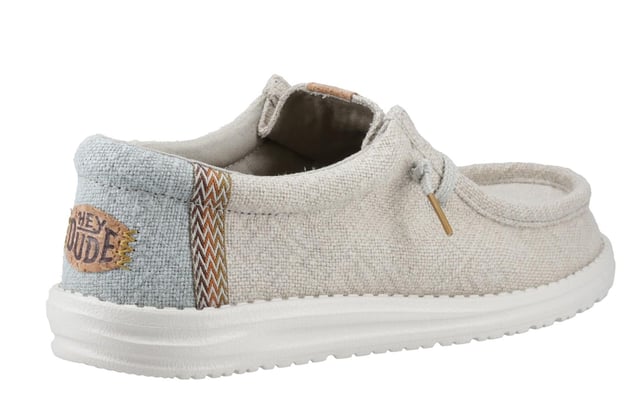 These Hey Dude Wally Jute Shoes bring a natural touch to your warm-weather wardrobe. Made from 100% jute, these shoes are lightweight, breathable, and perfect for spring and summer adventures. Designed with a textile upper, cork heel, and woven gradient heel webbing, they combine effortless style with unbeatable comfort. The elastic laces and easy-on system make them travel-friendly, while the removable foam insole ensures all-day cushioning. A flexible outsole adds the finishing touch for comfort on the go.
  Textile upper 
  Cork heel 
  Elastic laces for easy on/off wear 
  Travel-ready design with removable foam insole
  Lightweight flexible outsole for all-day comfort
  Hey Dude branding