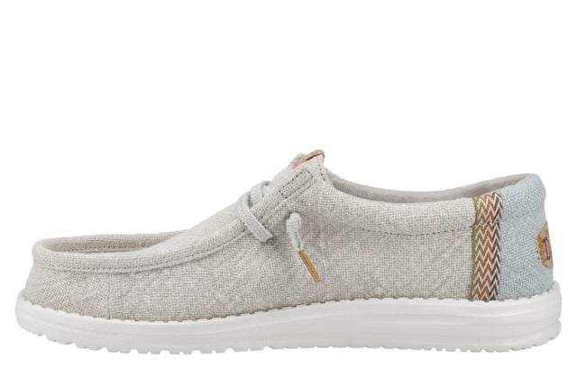These Hey Dude Wally Jute Shoes bring a natural touch to your warm-weather wardrobe. Made from 100% jute, these shoes are lightweight, breathable, and perfect for spring and summer adventures. Designed with a textile upper, cork heel, and woven gradient heel webbing, they combine effortless style with unbeatable comfort. The elastic laces and easy-on system make them travel-friendly, while the removable foam insole ensures all-day cushioning. A flexible outsole adds the finishing touch for comfort on the go.
  Textile upper 
  Cork heel 
  Elastic laces for easy on/off wear 
  Travel-ready design with removable foam insole
  Lightweight flexible outsole for all-day comfort
  Hey Dude branding