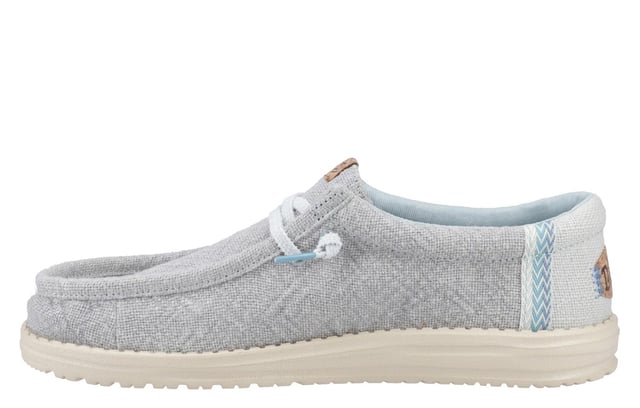 These Hey Dude Wally Jute Shoes bring a natural touch to your warm-weather wardrobe. Made from 100% jute, these shoes are lightweight, breathable, and perfect for spring and summer adventures. Designed with a textile upper, cork heel, and woven gradient heel webbing, they combine effortless style with unbeatable comfort. The elastic laces and easy-on system make them travel-friendly, while the removable foam insole ensures all-day cushioning. A flexible outsole adds the finishing touch for comfort on the go.
  Textile upper 
  Cork heel 
  Elastic laces for easy on/off wear 
  Travel-ready design with removable foam insole
  Lightweight flexible outsole for all-day comfort
  Hey Dude branding