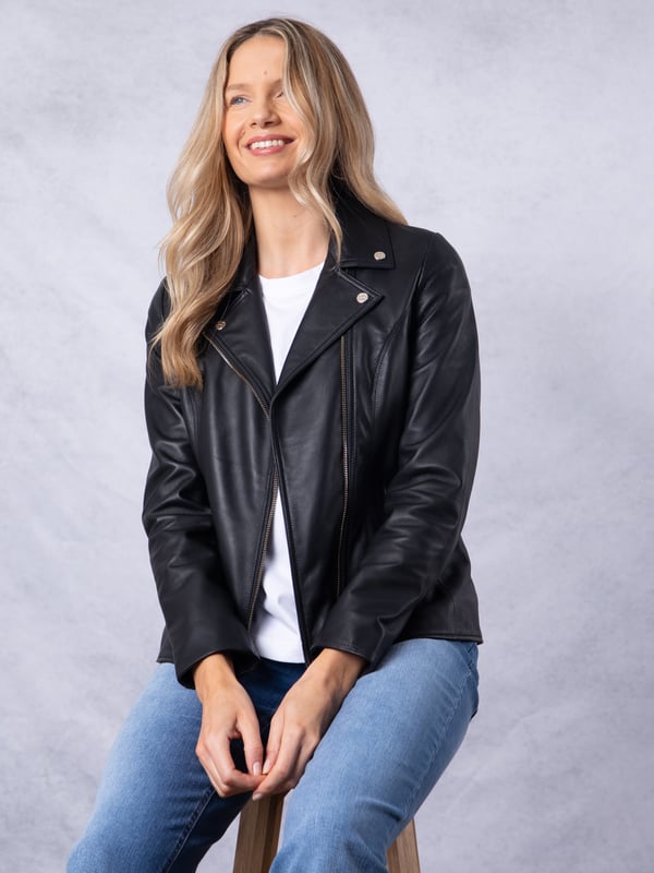 Knotts Leather Biker Jacket in Black The Knotts biker is a fresh update to the much-loved Kylee style, now introduced in two versatile shades.
Crafted from the finest semi aniline leather, this jacket embodies Lakeland Leather's commitment to quality and timeless design. It retains the iconic biker jacket elements, including an asymmetrical zip fastening, classic lapels, as well as sleek tonal hardware.
With its slightly longer length, the Knotts jacket is as versatile as it is flattering. Effortlessly pair it with jeans for a relaxed edge or drape it over a flowing dress for a chic contrast. Designed to suit all ages and seasons, this is a wardrobe essential with enduring appeal.