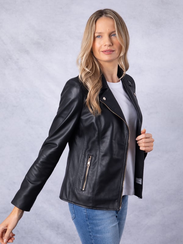 Knotts Leather Biker Jacket in Black The Knotts biker is a fresh update to the much-loved Kylee style, now introduced in two versatile shades.
Crafted from the finest semi aniline leather, this jacket embodies Lakeland Leather's commitment to quality and timeless design. It retains the iconic biker jacket elements, including an asymmetrical zip fastening, classic lapels, as well as sleek tonal hardware.
With its slightly longer length, the Knotts jacket is as versatile as it is flattering. Effortlessly pair it with jeans for a relaxed edge or drape it over a flowing dress for a chic contrast. Designed to suit all ages and seasons, this is a wardrobe essential with enduring appeal.