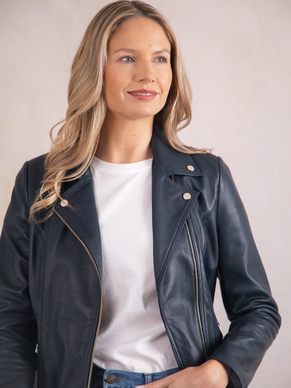 Knotts Leather Biker Jacket in Navy Blue The Knotts biker is a fresh update to the much-loved Kylee style, now introduced in two versatile shades.
Crafted from the finest semi aniline leather, this jacket embodies Lakeland Leather's commitment to quality and timeless design. It retains the iconic biker jacket elements, including an asymmetrical zip fastening, classic lapels, as well as sleek tonal hardware.
With its slightly longer length, the Knotts jacket is as versatile as it is flattering. Effortlessly pair it with jeans for a relaxed edge or drape it over a flowing dress for a chic contrast. Designed to suit all ages and seasons, this is a wardrobe essential with enduring appeal.