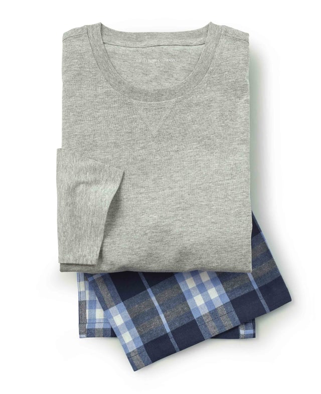 Relax in style with our men’s pyjama set, including a soft cotton jersey melange T-shirt that feels light and breathable, paired with cosy brushed cotton pyjama bottoms in a timeless blue and navy check pattern. The combination of soft, brushed cotton bottoms and a comfortable T-shirt creates the perfect blend of warmth and ease, making this set ideal for lounging or a peaceful night's sleep. 100% cotton jersey melange T-shirt with 100% brushed cotton lounge pant set. Long sleeved T-shirt with detail at neck. Fully elasticated waist with contrast herringbone lounge pant. One pocket at the back with embroidered logo. Machine washable at 40°C. Presented in fully recyclable packaging.