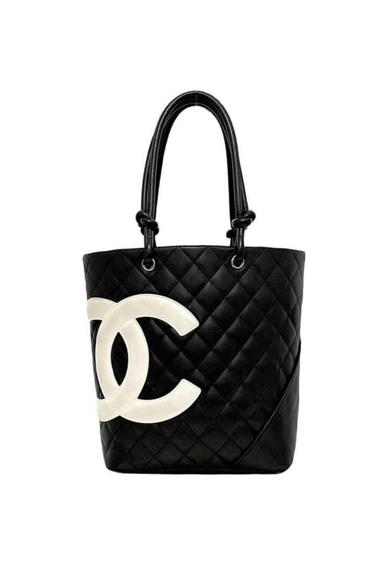 Brand: Chanel
Model: Cambon line
Color: Black
Material: Leather
Inclusions: /
Dimensions: 24.5cm x 20cm x 12cm
Serial number: 9445023
Country of origin: Italy
Condition: B - good condition.
This Chanel Cambon Line tote bag model A25166 is a chic accessory designed for women. Crafted from the iconic Cambon ligne material in black and white it features a spacious design with two zipper pockets and two pen holders inside.
The bag shows slight overall scratches and dirt with noticeable rubbing on the corners and some stains on the exterior. There are also scuff marks throughout but it remains a stylish and functional tote.
We recommend that you look at all the pictures before making your purchase to ensure that you are satisfied with the condition of the item.Brand: ChanelType: toteMain Material: Leather
