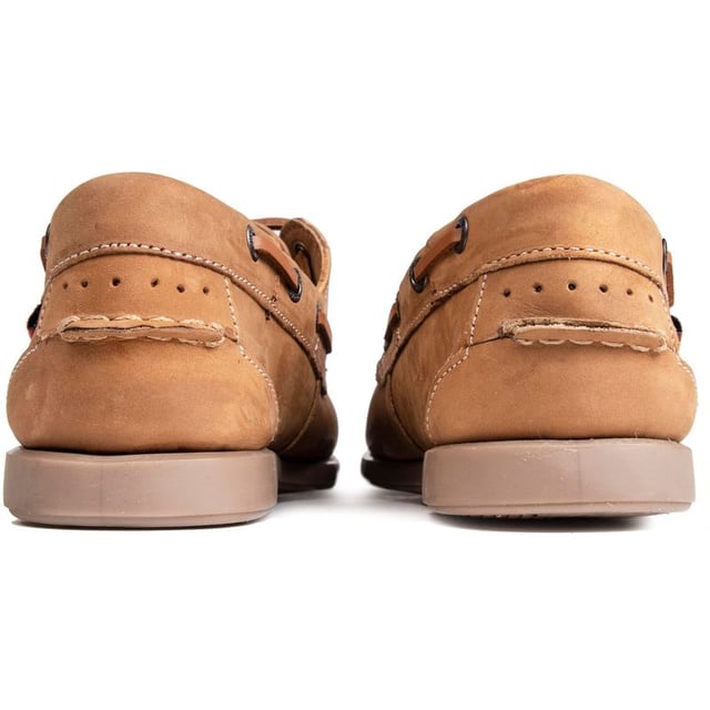 The Marine Bow boat shoe from Chatham Marine is ideal for those smart-casual days around town, casual evenings with friends and of course a warm breezy day out at sea. The superb light tan nubuck upper is of the highest quality and the moccasin-style slip-ons have a flexible rubber sole and brass metal eyelets around the sides to complete this luxurious look.