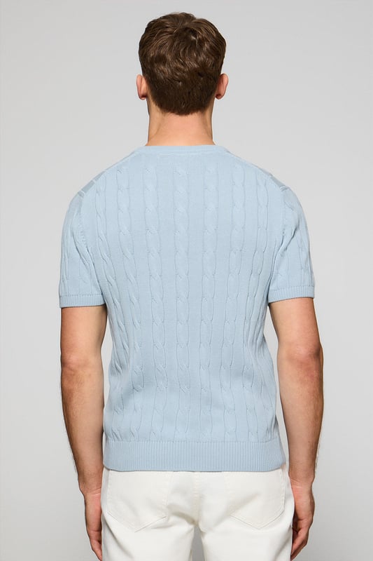 Unser kurzärmliger Zopfstrickpullover für Herren ist eine Neuheit in unserer Zopfmuster-Kollektion für diese Saison. Sein einzigartiges Flechtmuster verleiht ihm Struktur und Raffinesse, während gerippte Details an Kragen, Ärmeln und Saum für einen guten Sitz und ein elegantes Finish sorgen. Das dezente marineblaue Nahtband am Kragen mit Polo Club Logo unterstreicht die Eleganz dieses Modells. Die emblematische Rigby Go Stickerei in Kontrastfarbe auf der Brust unterstreicht seine einzigartige Optik. Ideal für einen eleganten und zeitlosen Look.