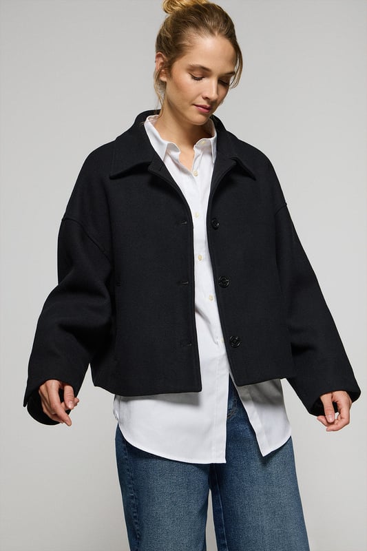 Unsere Lita Kurzjacke für Damen aus einem Woll-Polyester-Gemisch ist das ideale Kleidungsstück für einen modernen und eleganten Look. Der klassische Reverskragen und der Knopfverschluss mit Logoknöpfen auf der Vorderseite verleihen ihr eine raffinierte Note. Mit zwei praktischen Taschen auf der Vorderseite. Das Polo Club Logo auf der Passe verleiht ihr einen exklusiven Touch. Diese Jacke ist ein unverzichtbares Kleidungsstück, das perfekt zu Anzughosen oder, für einen legeren Look, zu Jeans mit hoher Taille passt.