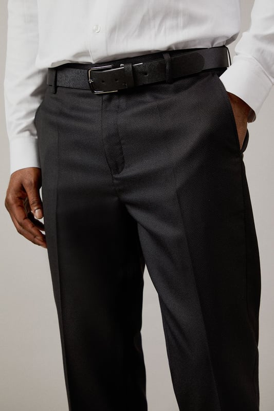 Slim fit design with a modern, tailored silhouette
        Textured fabric with added stretch for comfort and movement
        Clean front crease for a sharp, professional appearance
        Side pockets for practicality without compromising style
        Belt loops for versatile styling options
    
    These textured stretch trousers from Burton offer the perfect balance of comfort and sophistication. The slim fit design creates a contemporary silhouette that flatters without feeling restrictive, whilst the added stretch element ensures ease of movement throughout your day. Pair with a crisp white shirt and polished leather shoes for important meetings or client presentations. For smart casual occasions, try with a lightweight knit and Chelsea boots. The versatile charcoal tone makes these trousers an essential wardrobe staple that transitions seamlessly from office to evening drinks. Ideal for the man who values classic style with modern functionality - these trousers will quickly become your go-to for any occasion where you need to look the part without sacrificing comfort.