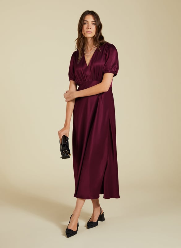 Description\nFits true to size, we suggest ordering your usual size.\nNothing spells evening glamour like a slinky, satin dress. The Cathy Midi Dress is made from responsibly-sourced Ecojilin satin, cut with an under-bust seam and a slim fit through the body. Its v-neck and statement sleeves add to the appeal. In a rich shade of burgundy, simply add heels and earrings for an effortlessly elegant, feelgood look.  \n\nMade in Europe\nCrafted in Ecojilin \nFastens with an invisible side zip \nMidi length \nV-shape neckline \n\n\nSustainable Attributes:\n\n\n Low impact\n \n Low Water Use \n \n Recycled Fibres \n\n Ethically made \n \n Low Carbon \n\n\nDetails\n Model is 5'10 (177cm) and is wearing a UK 10\n100% Ecojilin Viscose Dry Clean Only\nProduct Code: DR40637-BUY \nBack shoulder at neck to hem - 121cm (47 2/3)\nSleeve length - 29cm (11 3/8)
