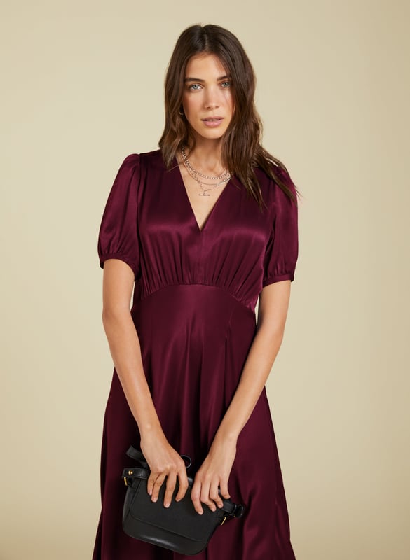 Description\nFits true to size, we suggest ordering your usual size.\nNothing spells evening glamour like a slinky, satin dress. The Cathy Midi Dress is made from responsibly-sourced Ecojilin satin, cut with an under-bust seam and a slim fit through the body. Its v-neck and statement sleeves add to the appeal. In a rich shade of burgundy, simply add heels and earrings for an effortlessly elegant, feelgood look.  \n\nMade in Europe\nCrafted in Ecojilin \nFastens with an invisible side zip \nMidi length \nV-shape neckline \n\n\nSustainable Attributes:\n\n\n Low impact\n \n Low Water Use \n \n Recycled Fibres \n\n Ethically made \n \n Low Carbon \n\n\nDetails\n Model is 5'10 (177cm) and is wearing a UK 10\n100% Ecojilin Viscose Dry Clean Only\nProduct Code: DR40637-BUY \nBack shoulder at neck to hem - 121cm (47 2/3)\nSleeve length - 29cm (11 3/8)