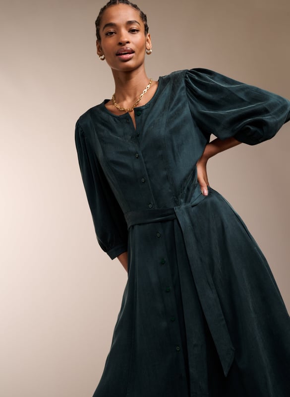 Description \n\nWhether it’s for brunch or work, you’ll feel ready for anything in Malin. This midi in recycled Cupro feels silky against the skin, and boasts a soft sheen in gorgeous green. It buttons all the way through and skims the waist to flatter. Tie with the self belt or a contrasting leather. It goes effortlessly with knee-high boots, loafers or mary-janes.  \n\n \nMade in Europe\n\nCrafted in recycled Cupro   \n\nPockets in side seams  \n\nCo-ordinating self-tie belt  \n\nElbow-length sleeves  \n\nSingle button cuffs  \n\n \n\n \n\nSustainable Attributes: \n\n Low Water Use   Recycled Fibres  Ethically made  \n\n \n\nDetails \n\n Model is 5'10 (177cm) and is wearing a UK 1053% Recycled Cupro, 47% Ecovero ViscoseDelicate Machine Wash 30˚Product code: DR40572-DAG Back shoulder at neck to hem - 119cm (46 7/8)Sleeve length - 48cm (18 7/8)