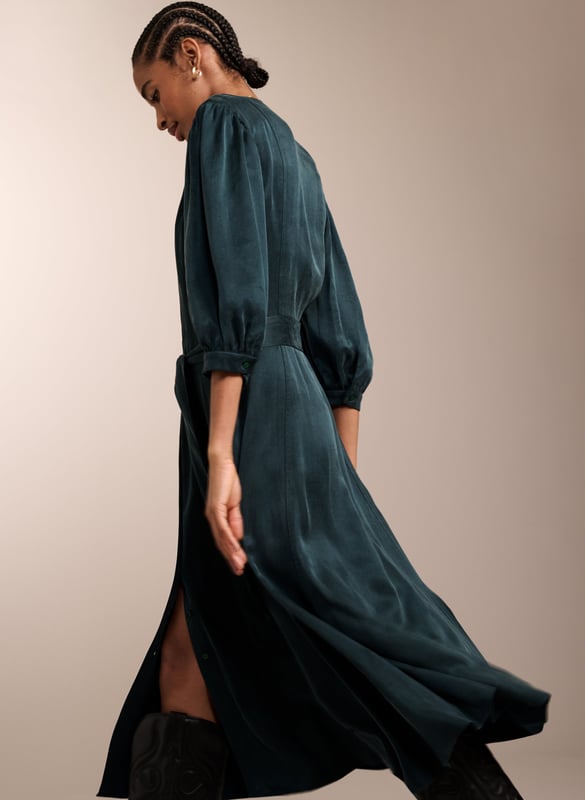 Description \n\nWhether it’s for brunch or work, you’ll feel ready for anything in Malin. This midi in recycled Cupro feels silky against the skin, and boasts a soft sheen in gorgeous green. It buttons all the way through and skims the waist to flatter. Tie with the self belt or a contrasting leather. It goes effortlessly with knee-high boots, loafers or mary-janes.  \n\n \nMade in Europe\n\nCrafted in recycled Cupro   \n\nPockets in side seams  \n\nCo-ordinating self-tie belt  \n\nElbow-length sleeves  \n\nSingle button cuffs  \n\n \n\n \n\nSustainable Attributes: \n\n Low Water Use   Recycled Fibres  Ethically made  \n\n \n\nDetails \n\n Model is 5'10 (177cm) and is wearing a UK 1053% Recycled Cupro, 47% Ecovero ViscoseDelicate Machine Wash 30˚Product code: DR40572-DAG Back shoulder at neck to hem - 119cm (46 7/8)Sleeve length - 48cm (18 7/8)