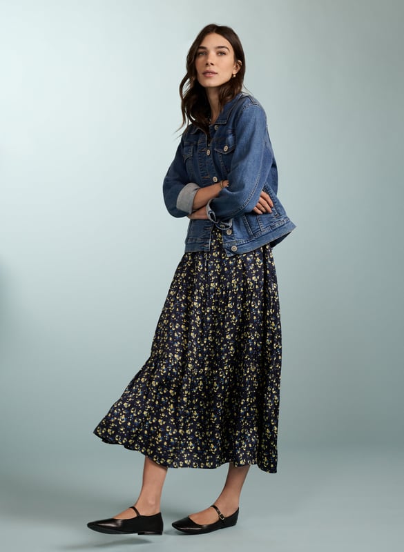 Description\nPurnita brings together details from our most popular dresses, such as a simple, throw-on shape with a tiered skirt, a button-down front, and of course - pockets! Its blurred ditsy print is so easy to style - see for yourself with leather biker or denim jackets, and any kind of footwear.  \n\nMade in Europe\nCrafted in a recycled satin blend \nElbow length sleeves with button fastening \nButtons to the waist seam \nMidi length \n\n\nSustainable Attributes:\n  Low impact \n   Low Water Use\n    Recycled Fibres \n   Ethically made\n   Vegan \n   \n\nDetails\nModel is 5'10 (177cm) and is wearing a UK 1049% LENZING™ ECOVERO™ Viscose, 51% Recycled ViscoseDelicate Machine Wash 30˚Product code: DR40568-BUDBack shoulder at neck to hem - 125cm (49 3/8)Sleeve length - 55cm (21 5/8)