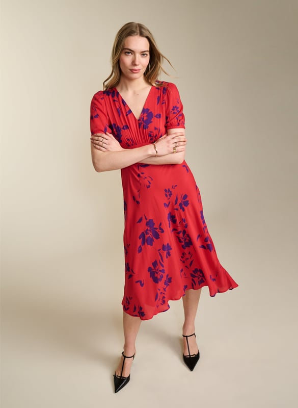 Description\nFits true to size, we suggest ordering your usual size.\nWith Kaydence, occasionwear is made easy. This chic midi will see you through weddings and christenings in unique style thanks to the unexpected pairing of a purple floral print on a bold red base. And then there’s the cut: wafty and A-line and slim through the waist with an under-the-bust seam. Prepare to turn heads!\n\nMade in Europe\nCrafted in LENZING™ ECOVERO™ crepe\nFastens with an invisible centre-back zip\nMidi length\nV-shape neckline\n\n\nSustainable Attributes:\n  Low Water Use  Ethically made  Vegan   \nDetails\nModel is 5'10 (177cm) and is wearing a UK 10100% LENZING™ ECOVERO™ ViscoseDelicate Machine Wash - 30°Product code: DR40614-RANBack shoulder at neck to hem - 124cm (48 7/8)Sleeve length - 27cm (10 5/8)