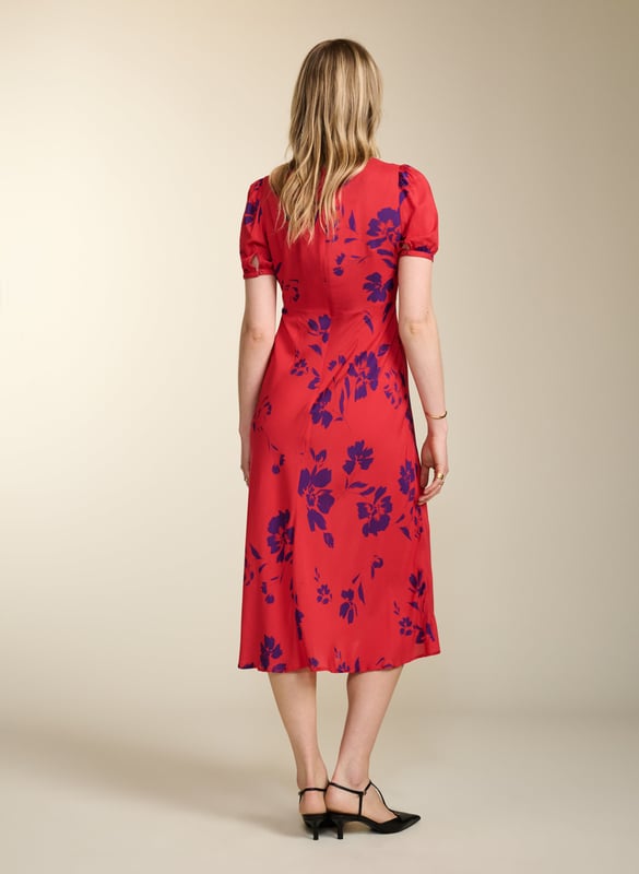 Description\nFits true to size, we suggest ordering your usual size.\nWith Kaydence, occasionwear is made easy. This chic midi will see you through weddings and christenings in unique style thanks to the unexpected pairing of a purple floral print on a bold red base. And then there’s the cut: wafty and A-line and slim through the waist with an under-the-bust seam. Prepare to turn heads!\n\nMade in Europe\nCrafted in LENZING™ ECOVERO™ crepe\nFastens with an invisible centre-back zip\nMidi length\nV-shape neckline\n\n\nSustainable Attributes:\n  Low Water Use  Ethically made  Vegan   \nDetails\nModel is 5'10 (177cm) and is wearing a UK 10100% LENZING™ ECOVERO™ ViscoseDelicate Machine Wash - 30°Product code: DR40614-RANBack shoulder at neck to hem - 124cm (48 7/8)Sleeve length - 27cm (10 5/8)