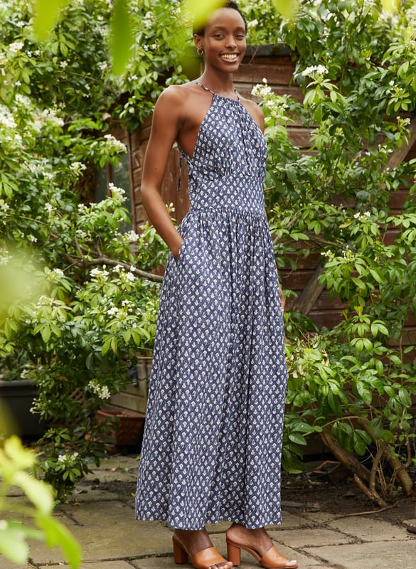 Description\nA word of warning: beautiful Sarai will quickly become your new favourite summer dress! This style in floaty voile features a pretty, woodblock-inspired print and fastens around the neck for an elegant halter-style shape. Whether it’s for balmy holiday nights or garden parties, you’ll want to wear it on repeat.  \nAn easy summer dress to live in when it’s hot. - Baukjen\n\nCrafted in LENZING™ ECOVERO™ voile\nPockets in side seams\nMaxi length\nFastens with a concealed side zip\n\n\nSustainable Attributes:\n Made in Europe  Low Water Use Ethically made   Vegan &gt; \n\nDetails\nModel is 5'10 (177cm) and is wearing a UK 10100% LENZING™ ECOVERO™ ViscoseDelicate Machine Wash - 30°Product code: DR40501-IWBBack shoulder at neck to hem - 140cm (55)