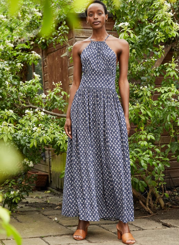 Description\nA word of warning: beautiful Sarai will quickly become your new favourite summer dress! This style in floaty voile features a pretty, woodblock-inspired print and fastens around the neck for an elegant halter-style shape. Whether it’s for balmy holiday nights or garden parties, you’ll want to wear it on repeat.  \nAn easy summer dress to live in when it’s hot. - Baukjen\n\nCrafted in LENZING™ ECOVERO™ voile\nPockets in side seams\nMaxi length\nFastens with a concealed side zip\n\n\nSustainable Attributes:\n Made in Europe  Low Water Use Ethically made   Vegan &gt; \n\nDetails\nModel is 5'10 (177cm) and is wearing a UK 10100% LENZING™ ECOVERO™ ViscoseDelicate Machine Wash - 30°Product code: DR40501-IWBBack shoulder at neck to hem - 140cm (55)