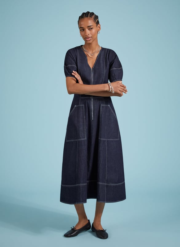 Description\nCoralie is a denim dress you can wear year-round: style it with bare legs and ballet pumps on milder days, then layer it with knee-high boots and a rollneck come winter. Crafted in raw, organic denim and defined by contrast stitching. An elasticated back panel is cut for a waist-accentuating fit and flare shape. Voluminous bell sleeves, and front zip opening top this contemporary design off.\n\nMade in Europe\nCrafted in organic cotton denim\nPockets\nContrast stitching\nBack elastic panel detail for shaping and fit\n\n\nSustainable Attributes:\n  Low Impact   Low Water Use   Natural fibres   Organic   Ethically made   Low Carbon \n\nDetails\nModel is 5'10 (177cm) and is wearing a UK 10100% Organic Cotton Delicate Machine Wash - 30°Product code: DR40576-DARBack shoulder at neck to hem - 123cm (48 3/8)Sleeve length - 31cm (12 1/4)