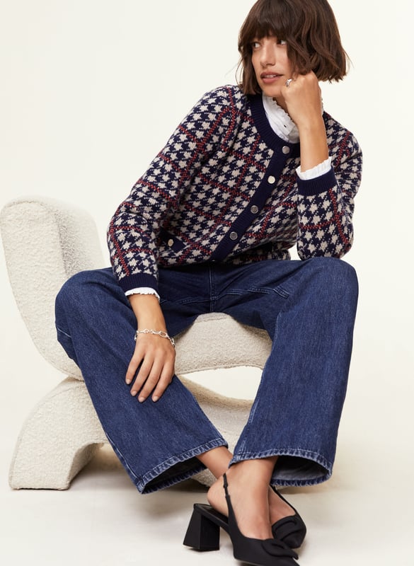 Description\nFits true to size, we suggest ordering your normal size.\nIs the Prudence a jacket or a cardigan? That’s your call, depending on how you style it! Wear it on its own with a mini skirt, or over a ruffle-collar blouse with jeans - the potential is limitless. Its classic houndstooth pattern in navy blue and beige is offset with an orange for a contemporary pop of colour.\nInspired by a family heirloom, Prudence is designed to give a little texture and joy to any outfit. Wear as a jacket or cardigan. I love how versatile it is. - Natalie, Design Director\n\nCrafted in a recycled wool blend\nBoxy fit\nFaux pockets\nSilver buttons\n\n\nSustainable Attributes:\n Made in Europe  Low Water Use   Mulesing free   Recycled Fibres  Ethically made   Raw Material Traced \n\nDetails\nModel is 5'10 (177cm) and is wearing a UK 1045% Merino Wool, 35% GRS Recycled Wool, 20% GRS Recycled NylonHand Wash Or Dry Clean OnlyProduct Code: KW40252-NANBack shoulder at neck to hem - 55cm (21 3/4)Sleeve length - 60cm (23 5/8)