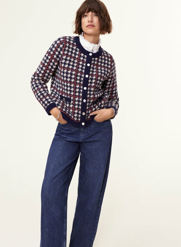 Description\nFits true to size, we suggest ordering your normal size.\nIs the Prudence a jacket or a cardigan? That’s your call, depending on how you style it! Wear it on its own with a mini skirt, or over a ruffle-collar blouse with jeans - the potential is limitless. Its classic houndstooth pattern in navy blue and beige is offset with an orange for a contemporary pop of colour.\nInspired by a family heirloom, Prudence is designed to give a little texture and joy to any outfit. Wear as a jacket or cardigan. I love how versatile it is. - Natalie, Design Director\n\nCrafted in a recycled wool blend\nBoxy fit\nFaux pockets\nSilver buttons\n\n\nSustainable Attributes:\n Made in Europe  Low Water Use   Mulesing free   Recycled Fibres  Ethically made   Raw Material Traced \n\nDetails\nModel is 5'10 (177cm) and is wearing a UK 1045% Merino Wool, 35% GRS Recycled Wool, 20% GRS Recycled NylonHand Wash Or Dry Clean OnlyProduct Code: KW40252-NANBack shoulder at neck to hem - 55cm (21 3/4)Sleeve length - 60cm (23 5/8)