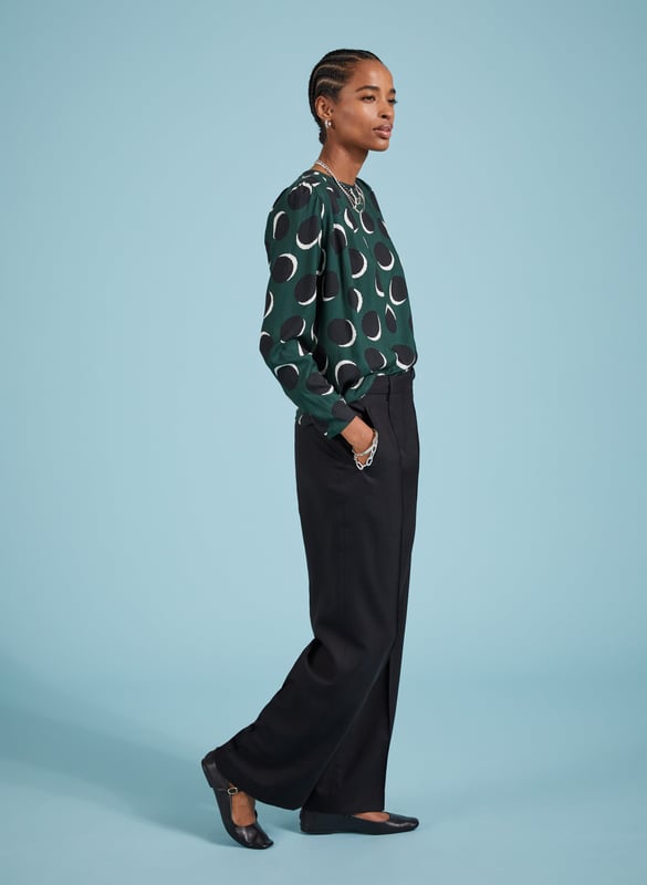 Description\nDottie is a printed blouse that is smart, comfortable and versatile. And will deliver when it comes to dressing for work or dinner. With its shadow spot pattern and beautiful drapey fabric, she won’t let you down. Wear it with tailored trousers for a look that’s as effortless as it is elegant.\n\nMade in Europe\nCrafted in Livaeco viscose\nRouleau loop button back neck fastening\nPleat detailing around shoulders\nRelaxed fit\n\n\nSustainable Attributes:\n  Low impact  Low Water Use   Recycled Fibres   Ethically made  Low Carbon \n\nDetails\nModel is 5'10 (177cm) and is wearing a UK 10100% LivaecoDelicate Machine Wash 30˚Product Code: TP40797-GSSBack shoulder at neck to hem - 62cm (24 2/5)Sleeve length - 62cm (24 3/8)