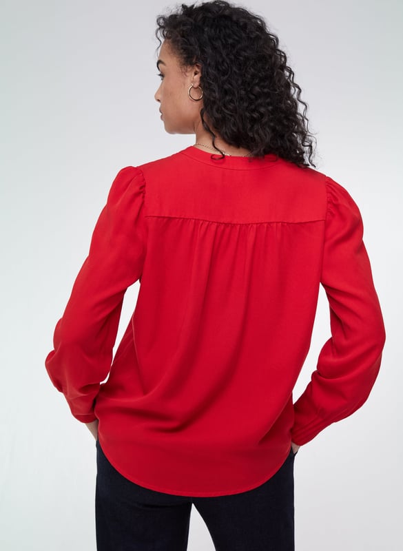 Description\nFits true to size, we suggest ordering your normal size.\nWhat our customers say: This is a beautiful blouse, and the material is really soft.\nWhether it’s for work or dinner, the Annika will instantly add a touch of feminine elegance to your looks. It comes with pretty, rouleau loop button fastenings, gathered shoulders and deep cuffs with pleated details on the outer section for that extra detail. It comes in a relaxed fit so it can easily be tucked in. This is a stunning blouse you will enjoy for years.\nChic and stunning - Baukjen\n\nMade from eco-friendly TENCEL™\nButton-through\nRelaxed fit\n\n\nSustainable Attributes:\n Made in Europe  Low Water Use Ethically made   Vegan  \n\nDetails\n100% LENZING TENCEL™ Delicate Machine Wash - 30°Product Code: SH40164-CRDBack shoulder at neck to hem - 65cm (25 5/8) Sleeve length - 64cm (25 1/4)