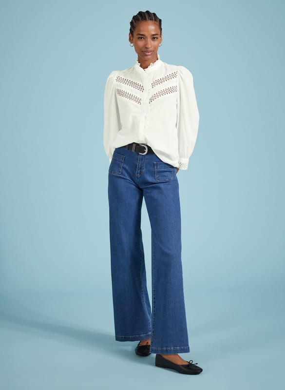 Description\nFits true to size, we suggest ordering your usual size.\nIf your weak spot is a romantic, white cotton blouse then prepare to be seduced by Isamaya! This style is loaded with panels of intricate broderie anglaise along the chest, and which also adorns the collar and front opening as a pretty ruffle. Even the cuffs are a moment, with more embroidery detail. Just add jeans for a feelgood, feminine outfit.\n\nMade in Europe\nCrafted in organic cotton voile\nButton cuffs\nGathering into sleeves and shoulders\n\n\nSustainable Attributes:\n  Natural fibres   Organic   Ethically made \nDetails\nModel is 5'10 (177cm) and is wearing a UK 10100% Organic Cotton Delicate Machine Wash - 30°Product code: SH40272-SFWBack shoulder at neck to hem - 61cm (24)Sleeve length - 56.5cm (22 1/4)