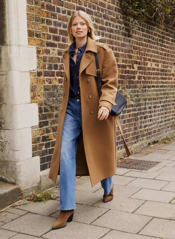 Description\nFits true to size, we suggest ordering your usual size.\nThe Ingrid Belted Trench Coat is a buy-now, wear-it-forever sort of wardrobe staple. Crafted in a heavy, recycled twill wool blend, it takes all its styling cues from the classic trench coat. Expect a double-breasted silhouette, epaulettes, storm flap and a belt. Beautifully cut and fully lined, it will elegantly elevate any outfit while offering maximum warmth. Whether it’s for weekdays or weekends, Ingrid can do it all. \n\nMade in Europe \nCrafted in a premium recycled wool blend \nTabs on cuffs \nFull length \nWelt pockets \n\n\nSustainable Attributes:\n\n\n Low Impact \n\n Low Water Use \n\n Mulesing free \n\n Natural fibres \n\n Recycled Fibres \n\n Ethically made \n\n\nDetails\nModel is 5'10 (177cm) and is wearing a UK 10\n65% Recycled Wool, 30% Recycled Polyester, 5% Other Fibres\nDry CLean Only\nProduct Code: OT40103-TAU \nBack shoulder at neck to hem - 120cm (47 1/4)\nSleeve length - 60cm (23 5/8)