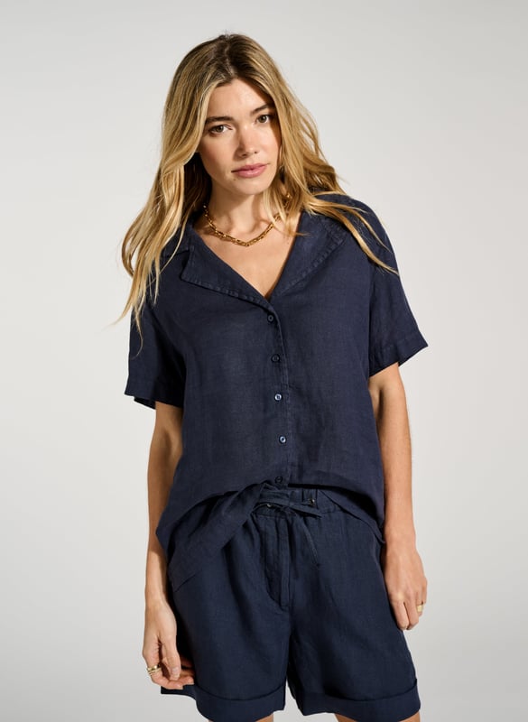 Description\nPyjama-inspired shirting + cooling linen = the ultimate summer top! Ethel is an effortless alternative to a tee; its open collar will elevate your favourite jeans or linen trousers on one easy move. For a fun, full look, pair it with the co-ordinating Marlow Shorts in the same shade of indigo. \n\nMade in Europe\nCrafted in pure linen \nRelaxed fit \nButtons through  \nMatching shorts available \n\n\nSustainable Attributes:\n\n\n Low Water Use\n\n Natural fibres\n\n Ethically made \n \n Vegan  \n\nDetails\nModel is 5'10 (177cm) and is wearing a UK 10\n100% Linen \nDelicate Machine Wash - 30°\nProduct code: SH40280-DPI \nBack shoulder at neck to hem - 63cm (24 7/8)\nSleeve length - 20cm (7 7/8)