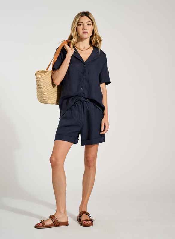 Description\nPyjama-inspired shirting + cooling linen = the ultimate summer top! Ethel is an effortless alternative to a tee; its open collar will elevate your favourite jeans or linen trousers on one easy move. For a fun, full look, pair it with the co-ordinating Marlow Shorts in the same shade of indigo. \n\nMade in Europe\nCrafted in pure linen \nRelaxed fit \nButtons through  \nMatching shorts available \n\n\nSustainable Attributes:\n\n\n Low Water Use\n\n Natural fibres\n\n Ethically made \n \n Vegan  \n\nDetails\nModel is 5'10 (177cm) and is wearing a UK 10\n100% Linen \nDelicate Machine Wash - 30°\nProduct code: SH40280-DPI \nBack shoulder at neck to hem - 63cm (24 7/8)\nSleeve length - 20cm (7 7/8)