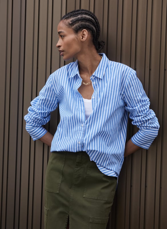 Description\nFits true to size, we suggest ordering your usual size.\nA crisp shirt is so versatile, there’s no such thing as having too many! We’ve created Rishma in organic cotton and classic, light blue and white stripes. With a borrowed-from-the-boys fit, it looks chic half-tucked into any style of trouser, dark and white jeans included.\n\nMade in Europe\nCrafted in organic, yarn-dyed cotton shirting\nSlightly oversized fit\nDeep cuffs\n\n\nSustainable Attributes:\n  Natural fibres    Organic   Ethically made  Vegan \n\nDetails\nModel is 5'10 (177cm) and is wearing a UK 10100% Organic Cotton Delicate Machine Wash - 40°Product code: SH40259-BSWBack shoulder at neck to hem - 73cm (28 3/4)Sleeve length - 60cm (23 5/8)
