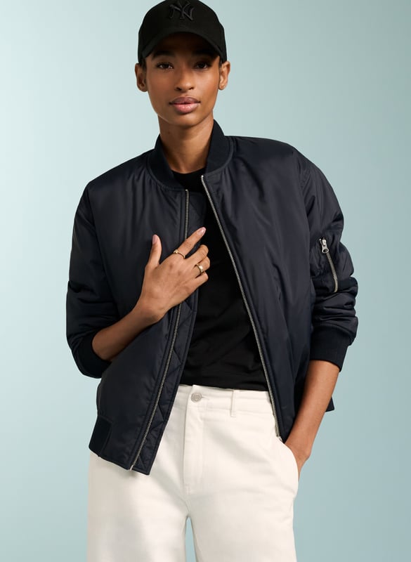Description\nFeatured in The Times.\nMy favourite (bomber) is from Baukjen, made from recycled fibres. Pair it with jeans, sure, but also – to keep things really up to date – with tailoring, or even evening wear. It’s the perfect sartorial slam dunk. - Anna Murphy, Fashion Director, The Times\nFits true to size, we suggest ordering your usual size.\nWe’re loving our Tegan Bomber jacket. Proudly crafted in recycled fibres, our zip-down bomber jacket is the ultimate lightweight layer, and the perfect partner to so many looks. Tegan features a zip patch pocket on one sleeve, front welt pockets and an internal breast pocket for your valuables. We’ve designed it slightly oversized for that cool, effortless look. Enjoy this for years.\n\nMade in Europe\nCrafted in 100% recycled fibres\nZip patch on sleeve\nSide pockets\n\n\nSustainable Attributes:\n  Low impact  Low Water Use  Recycled Fibres  Ethically made   Vegan    Low Carbon \n\nDetails\nModel is 5'10 (177cm) and is wearing a UK 10100% Recycled PolyesterHand wash Or Dry clean OnlyProduct code: OT40076-NAVBack shoulder at neck to hem - 61cm (24)Sleeve length - 59cm (23 1/4)