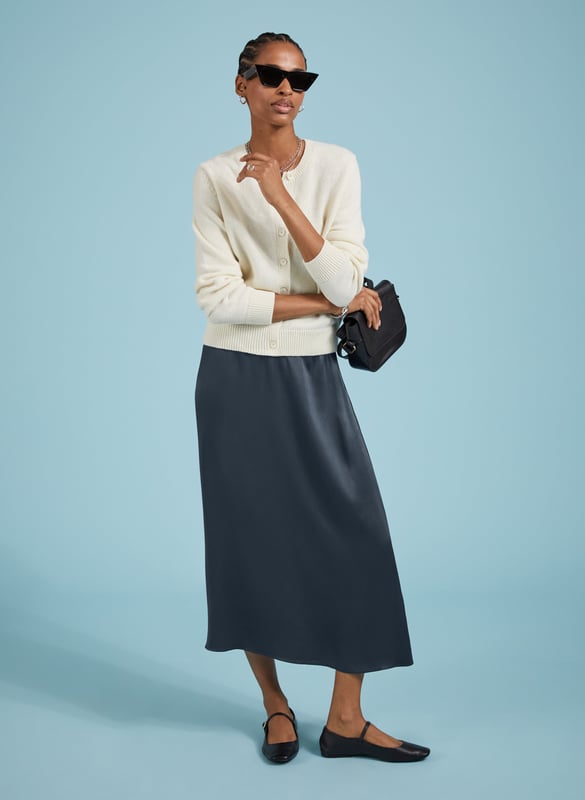 Description\nFits true to size, we suggest ordering your usual size.\nSlip skirts are enjoying a moment, and Doris is the easiest and most impactful style to update your wardrobe with. Crafted in satin-back crepe Ecojilin viscose, this style comes in a simple column shape, and features hidden elastic in the back of the waistband for comfort. In classic navy, it will add a considered twist to plain white tees or jumpers, and can easily be dressed-up with a blouse or camisole for nights out.\n\nMade in Europe\nCrafted in responsibly sourced Ecojilin viscose \nLong length\nFastens with an invisible side zip\nHidden elastic at back waist\n\n\nSustainable Attributes:\n  Low impact  Low Water Use   Recycled Fibres   Ethically made  Low Carbon \n\nDetails\nModel is 5'10 (177cm) and is wearing a UK 10100% Ecojilin ViscoseDry Clean OnlyProduct Code: SK40199-CLNCentre back waist to hem - 84cm (33)