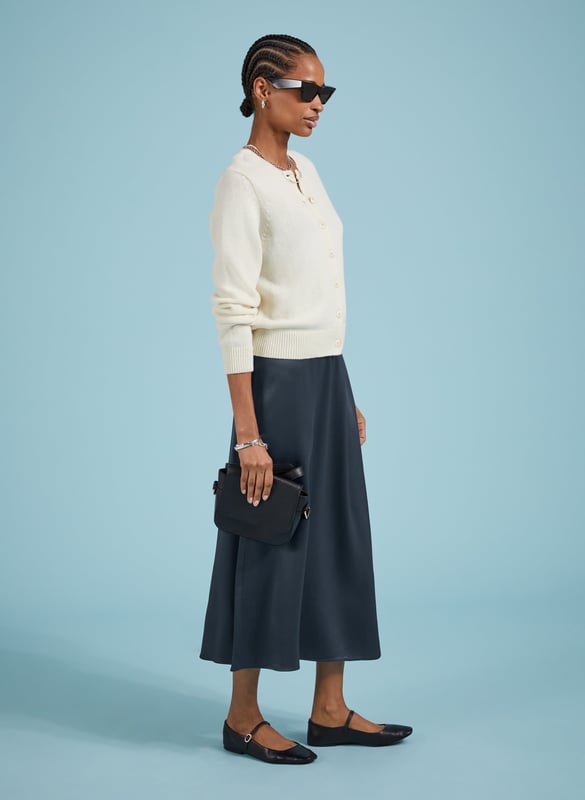 Description\nFits true to size, we suggest ordering your usual size.\nSlip skirts are enjoying a moment, and Doris is the easiest and most impactful style to update your wardrobe with. Crafted in satin-back crepe Ecojilin viscose, this style comes in a simple column shape, and features hidden elastic in the back of the waistband for comfort. In classic navy, it will add a considered twist to plain white tees or jumpers, and can easily be dressed-up with a blouse or camisole for nights out.\n\nMade in Europe\nCrafted in responsibly sourced Ecojilin viscose \nLong length\nFastens with an invisible side zip\nHidden elastic at back waist\n\n\nSustainable Attributes:\n  Low impact  Low Water Use   Recycled Fibres   Ethically made  Low Carbon \n\nDetails\nModel is 5'10 (177cm) and is wearing a UK 10100% Ecojilin ViscoseDry Clean OnlyProduct Code: SK40199-CLNCentre back waist to hem - 84cm (33)
