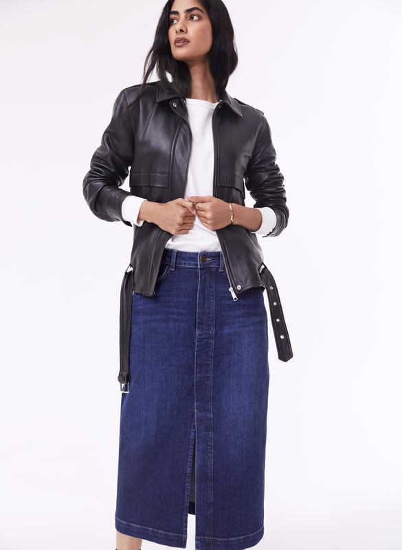 Description\nFits true to size, we suggest ordering your usual size.\nThe hot-ticket item right now according to our Design Director Natalie. A long-line denim skirt. In organic cotton of course. Emilia is a cool alternative to jeans, with a split up the front for a flash of leg and easy movement. It’s a versatile piece which hugs the waist and hips before tapering out into a chic column shape. So versatile, you can dress it up with loafers and a shirt, or down with a sweater and sneakers.\n\nCrafted in organic cotton denim\nLong midi length\nFront split detail\nZip button and fly fastening\nClassic jeans pockets\n\n\nSustainable Attributes:\n  Made in Europe    Natural fibres    Organic    Ethically made    Vegan    Low Carbon    Raw Material Traced \n\nDetails\nModel is 5'10 (177cm) and is wearing a UK 1099% Organic Cotton, 1% ElastaneDelicate Machine Wash - 30°Product code: SK40163-DIN Centre back waist to hem - 81cm (31 7/8)
