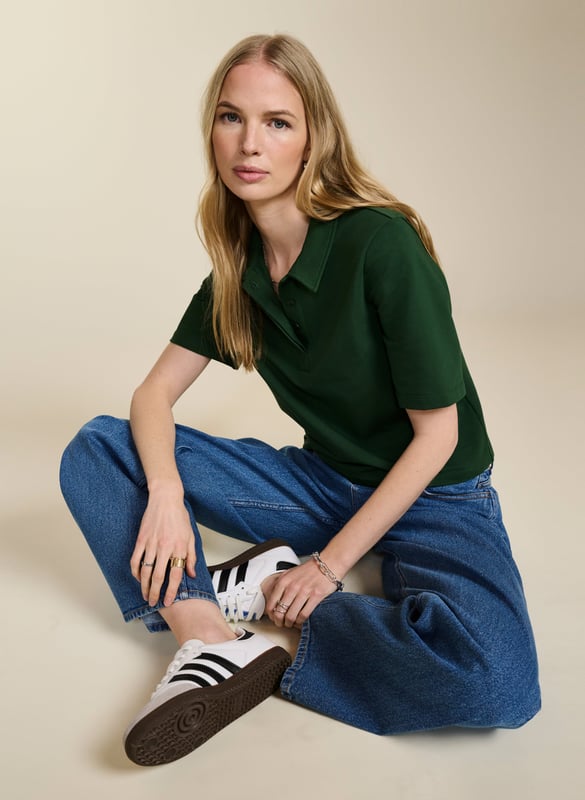 Description\nFits true to size, we suggest ordering your usual size.\nWe love the ease and versatility of a classic polo top. Margaret’s shape is slightly cropped with a relaxed fit and concealed buttons for a contemporary twist on a loyal piece. But best of all, this style is as low-impact as possible thanks to regenerative cotton, which is the most environmentally-conscious way of farming for fabrics. A proud new addition to Baukjen Lab. \n\nMade in Europe\nCrafted in regenerative cotton  \nRelaxed, cropped shape \nPulls on\n\n\nSustainable Attributes:\n\n\n Low Impact \n \n Low Water Use \n \n Natural fibres \n \n Ethically made \n\n Vegan \n \n Low Carbon \n\nDetails\n Model is 5'10 (177cm) and is wearing a UK 10\n96% Regen Cotton, 4% Elastane\nDelicate Machine Wash - 30°\nProduct code: TP40767-AQW \nBack shoulder at neck to hem - 53cm (20 7/8)\nSleeve length - 26.5cm (10 3/8)