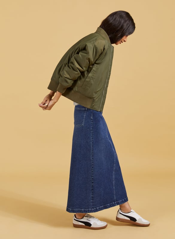 Description\nThe Nia skirt is nostalgic dressing at its finest! This style in organic cotton denim is quite literally a jeans skirt, with the waistband and fastenings borrowed from a classic pair of jeans. It’s cut to hug the waist and hips before gently flaring out into an a-line shape. A casual saviour, we’ll be wearing it with tees, boyfriend shirts and bomber jackets.\n\nMade in Europe\nCrafted in organic cotton denim\nStretchy\nAnkle length\nZip fly and button fastening\n\n\nSustainable Attributes:\n\n  \n Low Impact \n\n Low Water Use \n    Natural fibres \n    Ethically made \n    Organic \n\nDetails\nModel is 5'10 (177cm) and is wearing a UK 1099% Organic Cotton, 1% ElastaneProduct code: SK40178-DINCentre back waist to hem - 92cm (36 ⁷/₃₂)