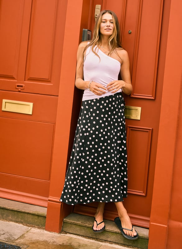 Description\nFits true to size, we suggest ordering your usual size.\nInspired by the best of 90s styling, Celeste is a classic wrap skirt with a timeless polka dot print. Long in length and cut for a a sleek silhouette, it’s a versatile piece to dress up or down. Reach for a jean jacket and mary janes for an easy weekend outfit, or dress it up with slingbacks and a crisp white shirt for relaxed glamour.\n\nMade in Europe\nCrafted in recycled Cupro\nFunctional wrap tie\nLong length\n\n\nSustainable Attributes:\n\n  \n Low Impact \n    Low Water Use\n  \n Natural fibres \n    Ethically made\n    Recycled Fibres \n\n\nDetails\nModel is 5'10 (177cm) and is wearing a UK 1053% Recycled Cupro, 47% Ecovero ViscoseDry Clean OnlyProduct code: SK40190-BPDCentre back waist to hem - 87cm (34 1/4)