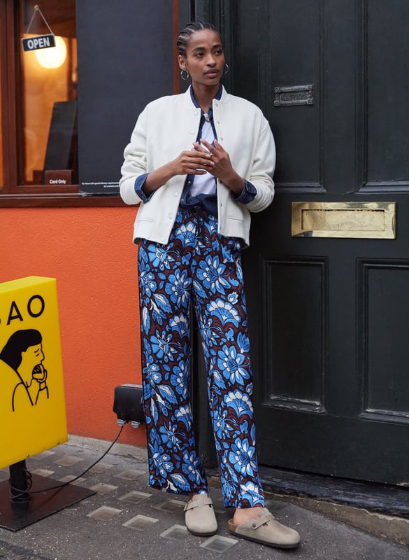 Description\nA building blend of pattern and colour, the Mandy are surprisingly versatile. Guaranteed to lend a touch of fun to casual tees, they look chic with a crisp white blouse. But our favourite way to style them is with the matching Gloria blouse for a fun and fearless outfit. Cut as a wide-leg, they are the ultimate spring-in-your-step piece. Enjoy for years. \n\nMade in Europe\nCrafted from a recycled satin blend \nElasticated waist with draw-cord \nSide slash pockets  \nWide-leg, relaxed fit \nBlack piping detail down each leg \nMatching top available \n\n\nSustainable Attributes:\n \n\n Low impact \n\n Low Water Use\n \n Recycled Fibres \n\n Ethically made\n\n Vegan \n\n\n\nDetails\n Model is 5'10 (177cm) and is wearing a UK 10\n49% LENZING™ ECOVERO™ Viscose, 51% Recycled Viscose\nDelicate Machine Wash 30˚\nProduct code: TR40313-BFA\nInside leg - 77cm (30 1/4)