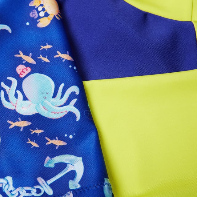Bring the magic of the ocean to life with our Water Explorers range. Featuring bold colours and a nautical\u0002themed sailboat print  this Short Sleeve Rash Top Set appeals to your little one’s sense of fun and includesa matching top and shorts. The pull-on rash top provides coverage for their shoulders  tummy and backand includes UV protective fabric of UPF40+ for sun protection in and out of the water. Designed for alltheir water adventures  our EnduraBrite fabric offers higher chlorine resistance than standard swimwearfabrics  delivers superb colour performance and fits like new for longer with CREORA® HighClo™. Made inpart from recycled plastic bottles - polyester yarns in the Endurabrite fabric are made from 100% pos