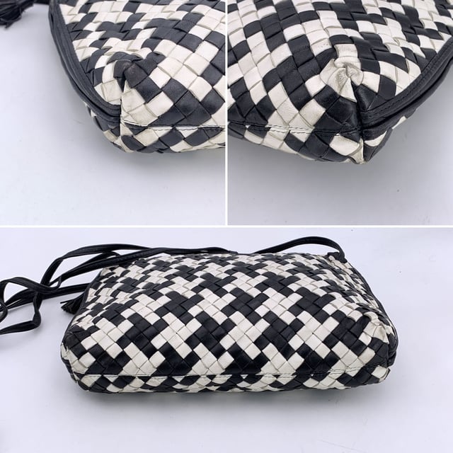 VINTAGE, RRP AS NEW
A rare find for true connoisseurs of vintage luxury, this Bottega Veneta Nodini shoulder bag is a stunning example of the brand's mastery in leather artistry. Crafted from supple nappa leather, its iconic Intrecciato weave is reimagined in a striking black-and-white pied-de-poule pattern-bold yet elegant, with a graphic rhythm that speaks to timeless Italian sophistication.  The compact silhouette features an upper zipper closure that opens to reveal a sleek black satin lining and a practical side zip pocket for your essentials. Inside, the "Bottega Veneta - Made in Italy" tag and the original certification label affirm its ity and heritage.  Both distinctive and understated, this vintage Nodini is more than just a bag-it's a piece of wearable craftsmanship, echoing the quiet luxury and artisanal spirit that define Bottega Veneta's legacy. Condition Rating: B - VERY GOOD CONDITIONCondition Details: Gently used. Some darkness on white leather. Some wear of use on bottom corners. Please check the photos carefully and ask if you need to know more details or if you have any doubts.Measurements (cm):Depth: 6.4Height: 20.3Length: 30.5Other Details: Dustbag? NoKeys? NoBox? No Measurments:  width: 64 mm length: 305 mm height: 203 mm