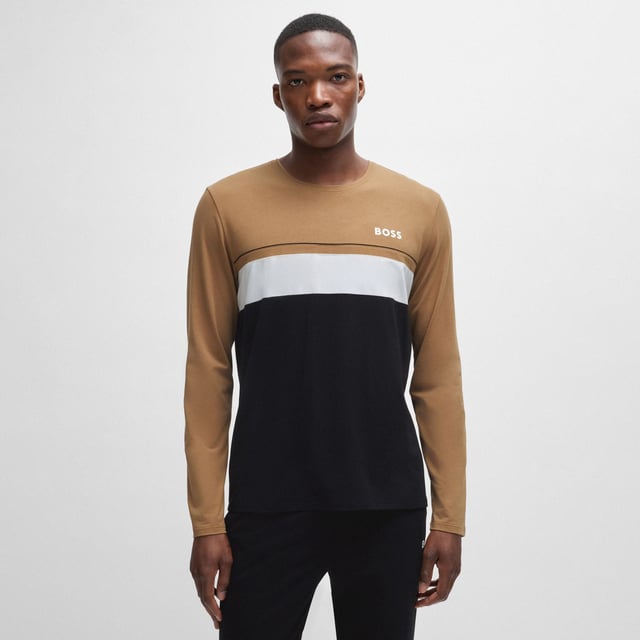Men's Boss Long Sleeved Logo Print Pyjama T-Shirt. Pajama top from the BOSS collection. Model made of cotton knit fabric.- Classic round neckline.- Long sleeves.- Decorative seams.- Logo patch on the front.- Fine, elastic knit.- Heatseal Logo.- Contrast piping and inserts. Material: 55% Cotton, 37% Modal, 8% Elastane. Ref: 50527337001.