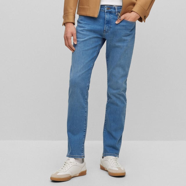 Men's Boss Delaware3-1 Slim-Fit Jeans. Slim Fit Jeans with a modern feel, borrowing the best elements of denim to create a pair that is simultaneously functional and fashionable. This pair features a blue wash design with tonal hardware logo at front pocket and distressed logo at rear waistband. Material: 99% Cotton, 1% Elastane. Ref: 50496102445.
