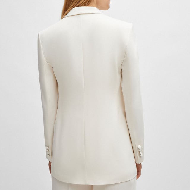 Women's Boss Jirea Regular-Fit Blazer. A fully lined jacket by BOSS Womenswear, tailored to a regular fit in matte fabric with an edge-to-edge front. For our BETTER BOSS products, we always use at least 60% better raw materials. This product is made with cellulose fibres, derived from natural raw wood material and sourced from responsibly managed forests. We cooperate with external organisations to ensure respectful treatment of virgin and endangered forests. Ref: 50512808118.