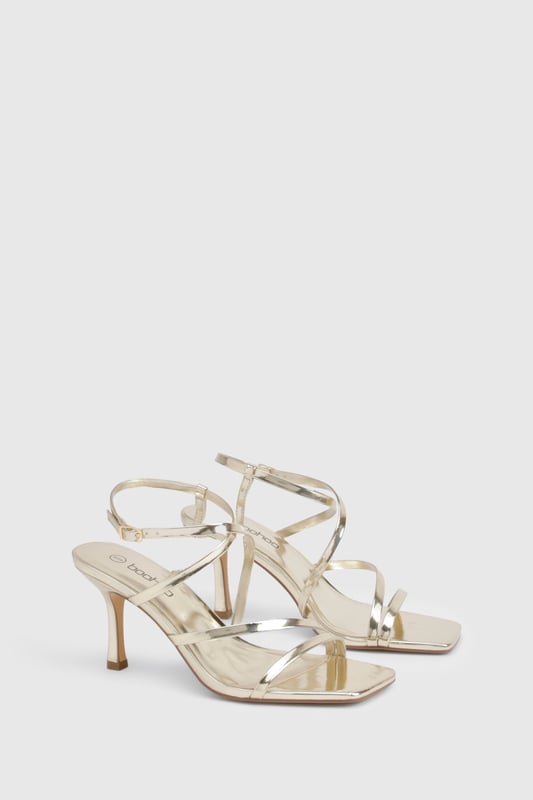 Striking metallised finish that catches the light beautifully
        Elegant strappy design with multiple thin bands for a delicate look
        Adjustable ankle strap with buckle fastening for a secure fit
        Sophisticated 7-9cm heel height perfect for evening occasions
        Square-toe silhouette for a contemporary touch
    
    These metallised basic heels from Boohoo are the versatile showstopper your night-out wardrobe needs. The delicate strappy design creates a flattering effect on the foot while providing just the right amount of support for dancing the night away. Style them with a sleek midi dress for cocktails with the girls, or pair with your favourite jeans and a statement top when heading to the bar. The moderate heel height strikes the perfect balance between comfort and height, making these ideal for extended wear during those spontaneous nights that turn into early mornings. Their neutral metallic finish ensures they'll complement virtually any outfit in your collection, making them a true wardrobe hero for any social occasion.