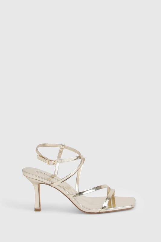 Striking metallised finish that catches the light beautifully
        Elegant strappy design with multiple thin bands for a delicate look
        Adjustable ankle strap with buckle fastening for a secure fit
        Sophisticated 7-9cm heel height perfect for evening occasions
        Square-toe silhouette for a contemporary touch
    
    These metallised basic heels from Boohoo are the versatile showstopper your night-out wardrobe needs. The delicate strappy design creates a flattering effect on the foot while providing just the right amount of support for dancing the night away. Style them with a sleek midi dress for cocktails with the girls, or pair with your favourite jeans and a statement top when heading to the bar. The moderate heel height strikes the perfect balance between comfort and height, making these ideal for extended wear during those spontaneous nights that turn into early mornings. Their neutral metallic finish ensures they'll complement virtually any outfit in your collection, making them a true wardrobe hero for any social occasion.