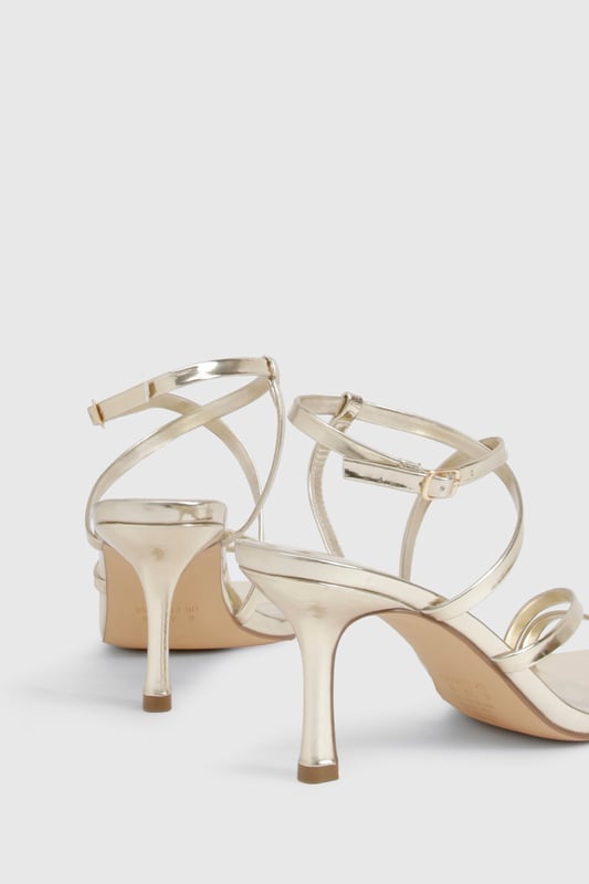 Striking metallised finish that catches the light beautifully
        Elegant strappy design with multiple thin bands for a delicate look
        Adjustable ankle strap with buckle fastening for a secure fit
        Sophisticated 7-9cm heel height perfect for evening occasions
        Square-toe silhouette for a contemporary touch
    
    These metallised basic heels from Boohoo are the versatile showstopper your night-out wardrobe needs. The delicate strappy design creates a flattering effect on the foot while providing just the right amount of support for dancing the night away. Style them with a sleek midi dress for cocktails with the girls, or pair with your favourite jeans and a statement top when heading to the bar. The moderate heel height strikes the perfect balance between comfort and height, making these ideal for extended wear during those spontaneous nights that turn into early mornings. Their neutral metallic finish ensures they'll complement virtually any outfit in your collection, making them a true wardrobe hero for any social occasion.